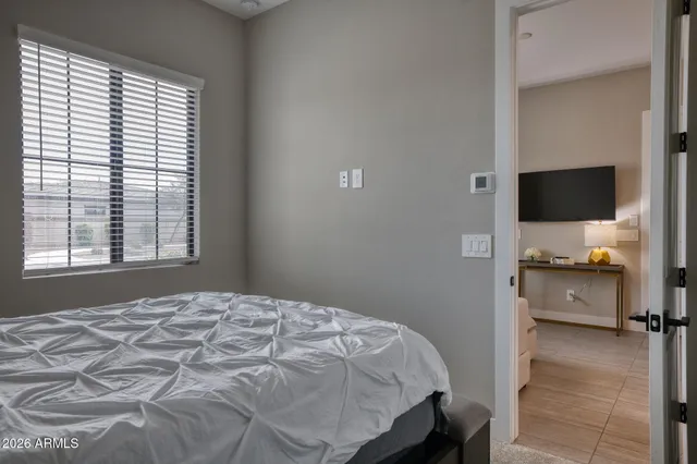 a bedroom with a bed and a flat screen tv