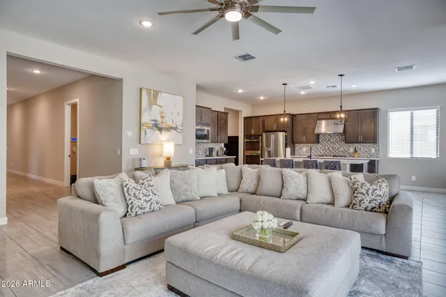 a living room with furniture and kitchen view