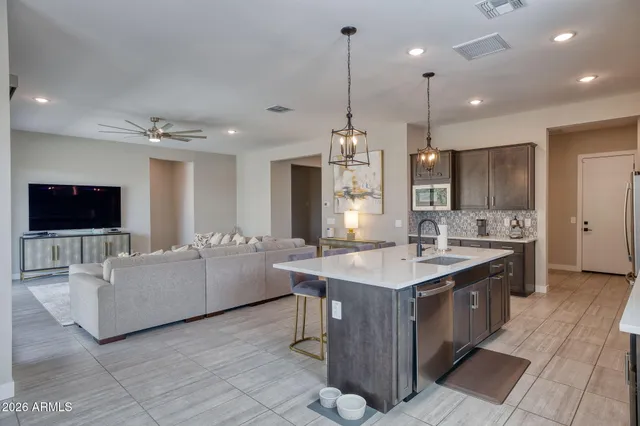 a large kitchen with kitchen island a sink a counter space and stainless steel appliances