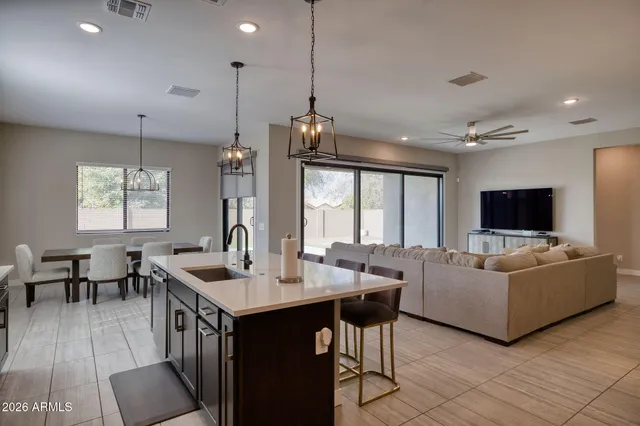 a living room with furniture a flat screen tv and a large window