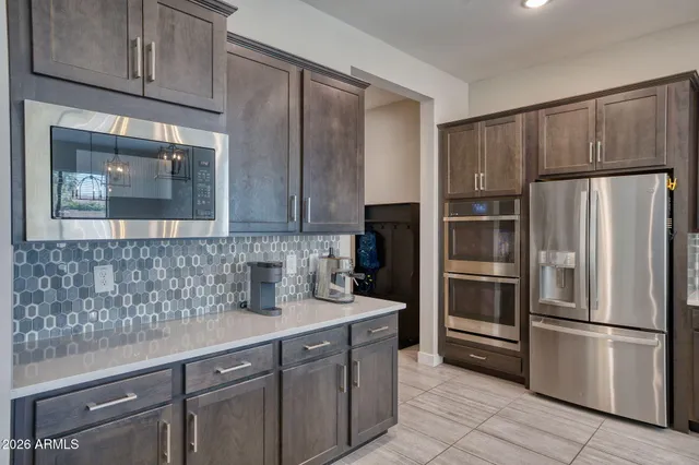 a kitchen with stainless steel appliances granite countertop a refrigerator and a sink