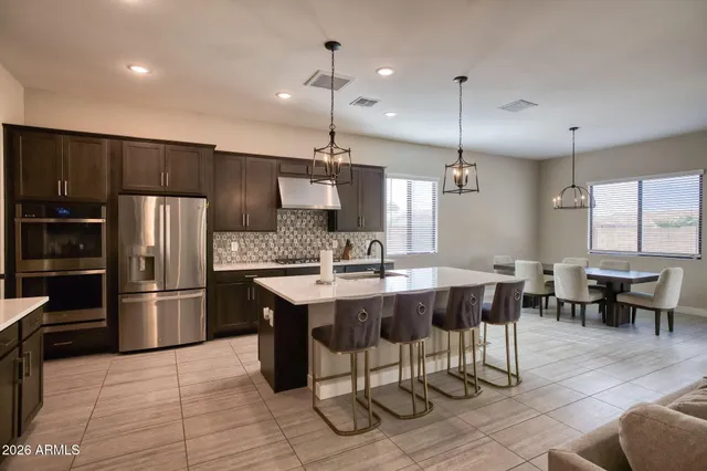 a large kitchen with a table and chairs