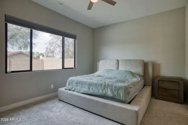 a bedroom with a bed and a window