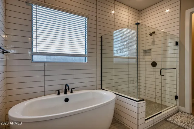 a bathroom with a white sink a toilet and shower