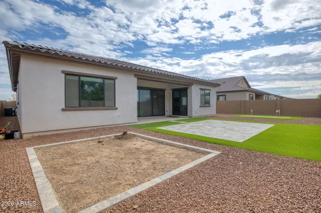 a view of pool with yard in front of it