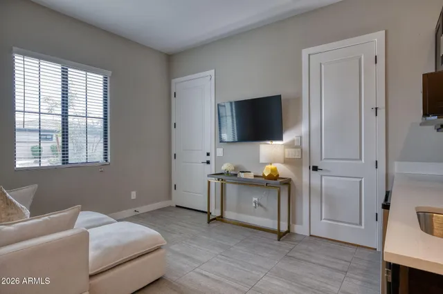 a bedroom with furniture and a flat screen tv