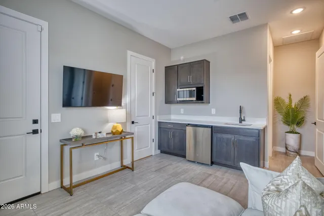 a spacious bathroom with a double vanity sink a mirror and a bathtub