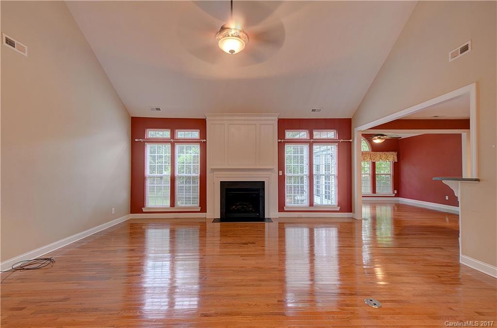 716 Beille Lane Fort Mill, SC 29708 - Photo 11 of 24 a view of empty room with wooden floor and fireplace