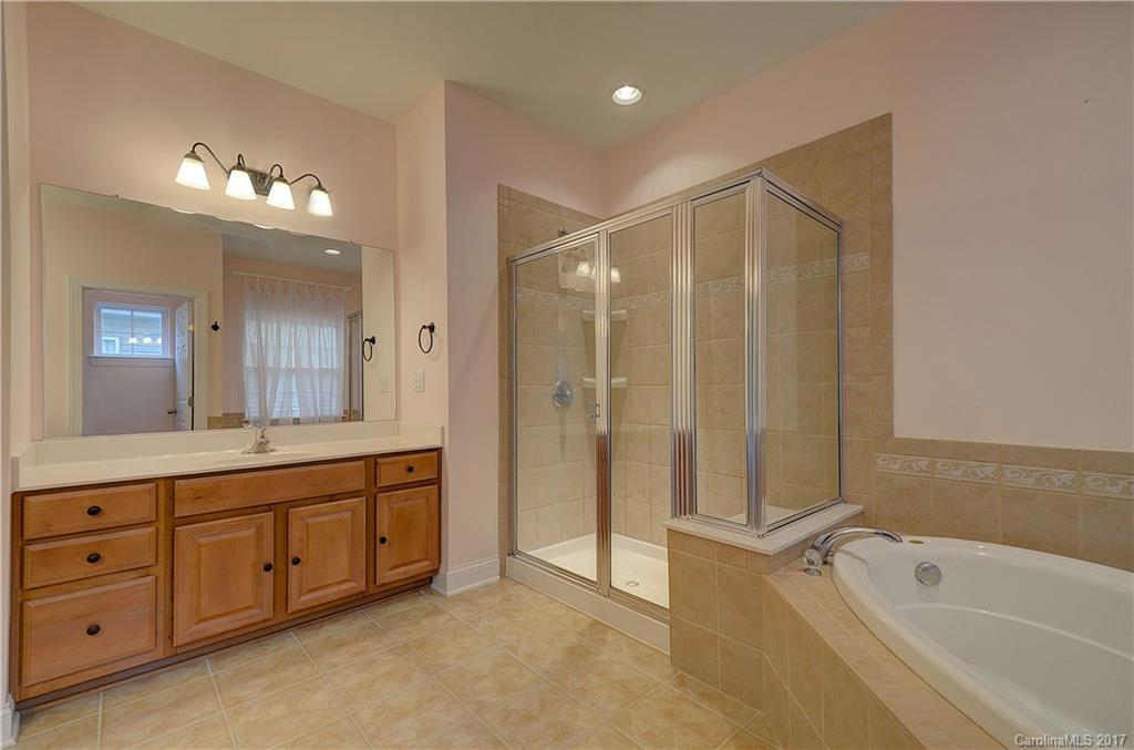 716 Beille Lane Fort Mill, SC 29708 - Photo 15 of 24 a spacious bathroom with a tub sink and mirror
