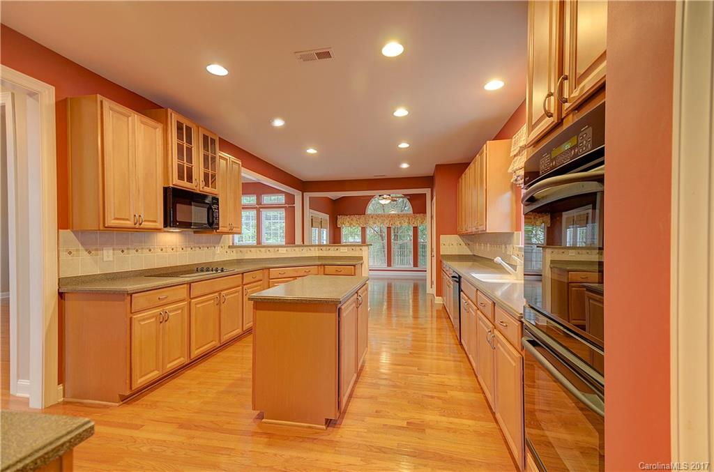 716 Beille Lane Fort Mill, SC 29708 - Photo 6 of 24 a kitchen with stainless steel appliances granite countertop a refrigerator a sink dishwasher a stove and a microwave oven with wooden floor