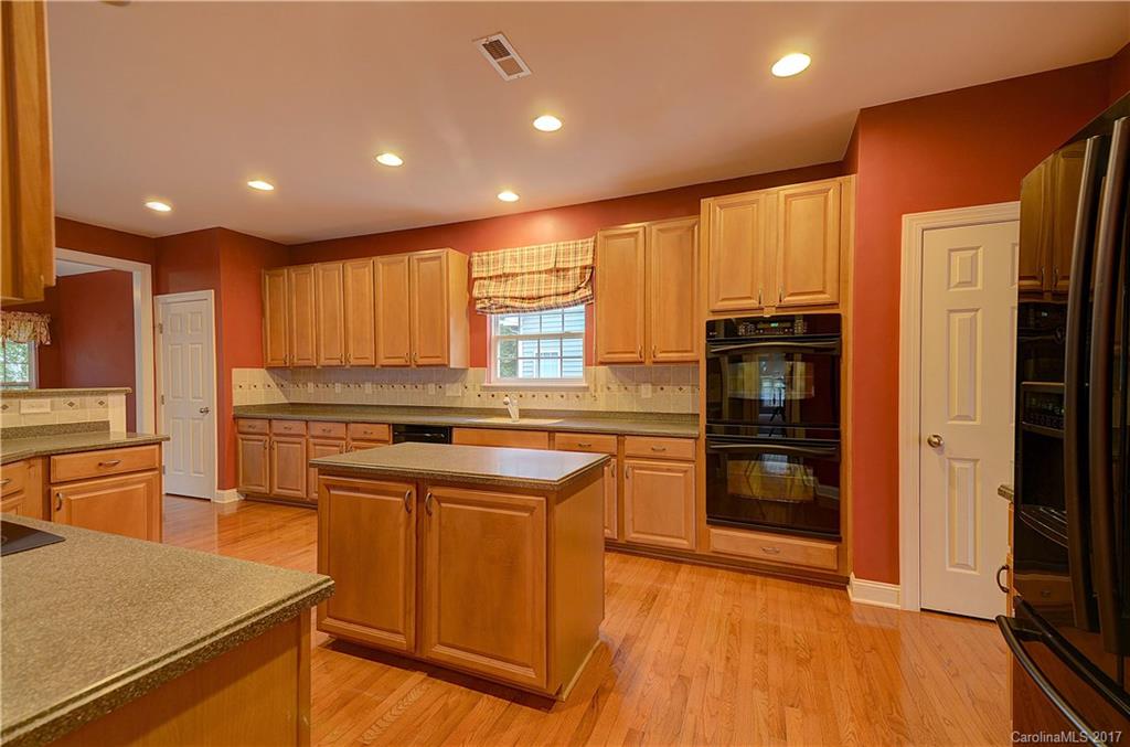 716 Beille Lane Fort Mill, SC 29708 - Photo 7 of 24 a kitchen with stainless steel appliances granite countertop a refrigerator a sink and a stove