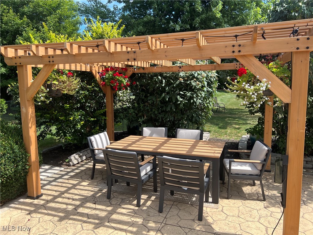 5912 Coen Road Vermilion, OH 44089 - Photo 23 of 28 View of patio with outdoor dining space and a pergola