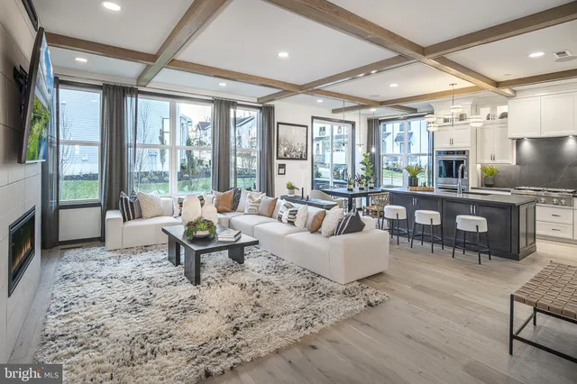 a living room with furniture and large windows