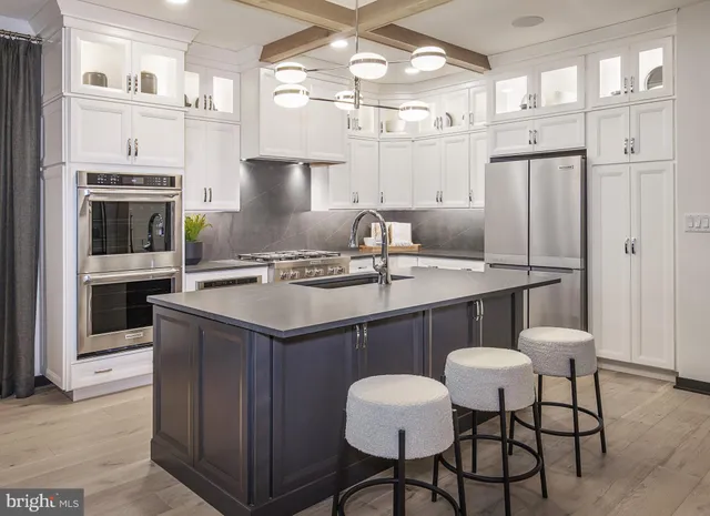 a kitchen with stainless steel appliances a sink and a refrigerator