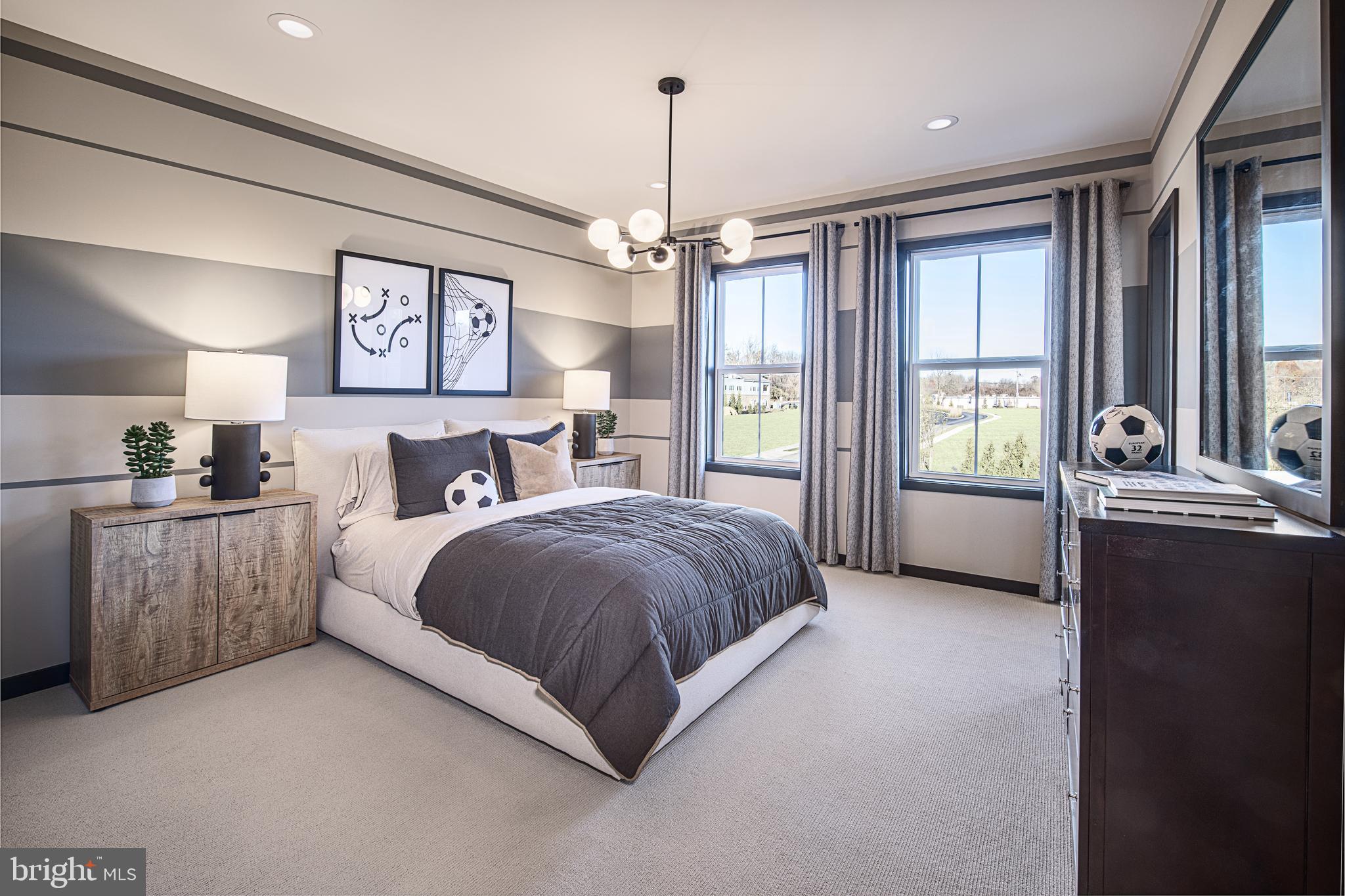 0 The Willis Elite Malvern, PA 19355 - Photo 7 of 19 a spacious bedroom with a bed and a chandelier