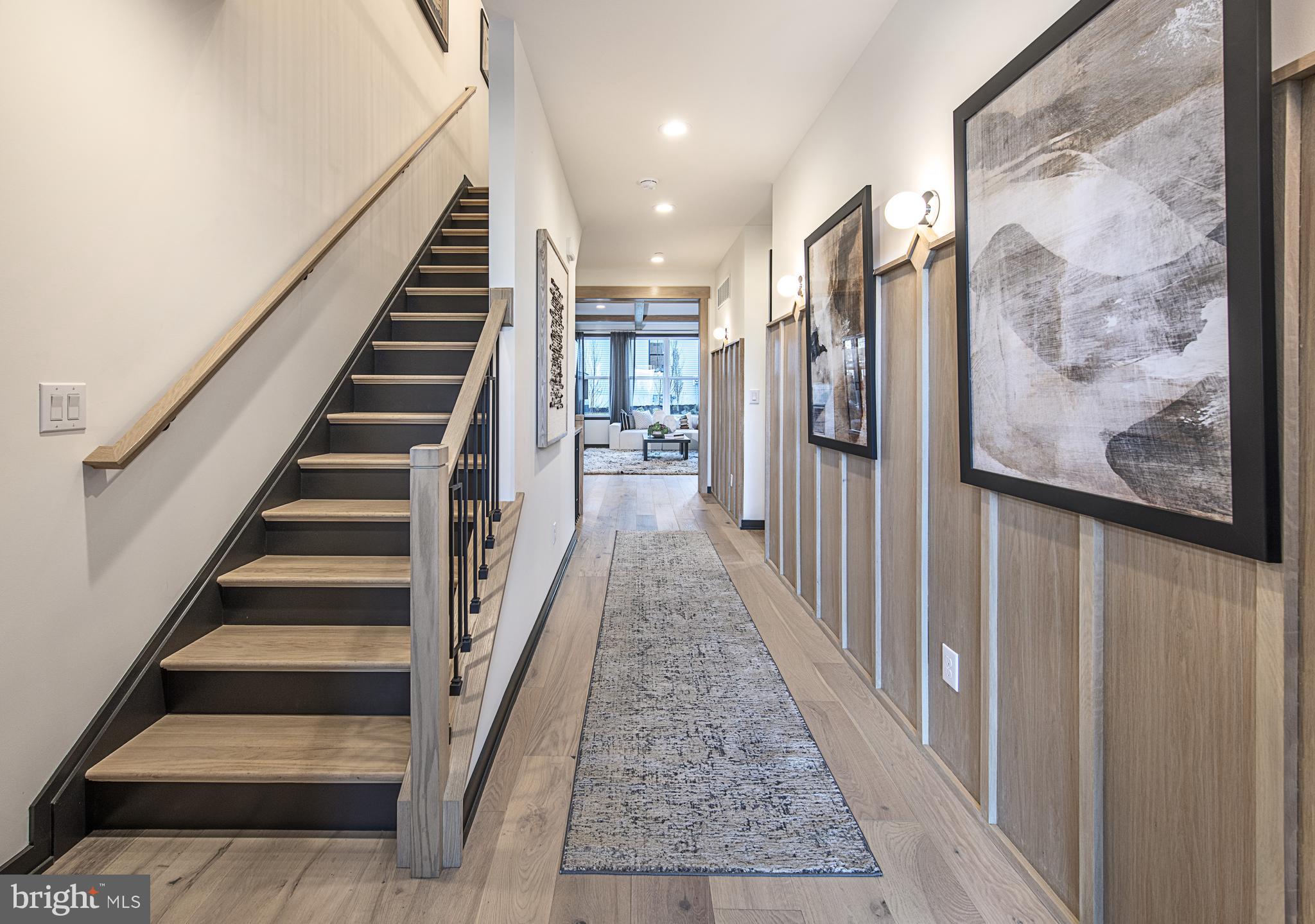 0 The Willis Elite Malvern, PA 19355 - Photo 8 of 19 a view of staircase with lots of frames on wall and windows