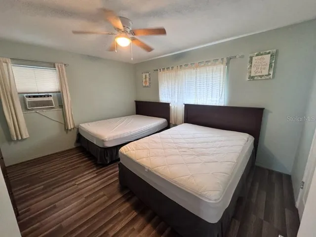 a bedroom with two beds and a chandelier