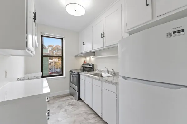 a kitchen that has a sink and a stove