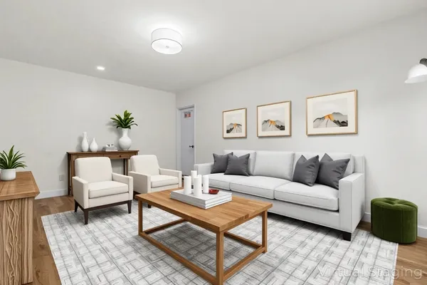 a living room with furniture and wooden floor