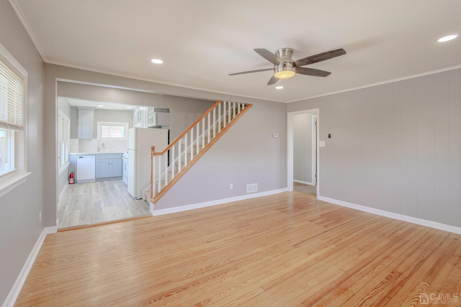 49 Riva Avenue, Unit 2 Milltown, NJ 08850 - Photo 12 of 22 a view of an empty room with a window and wooden floor