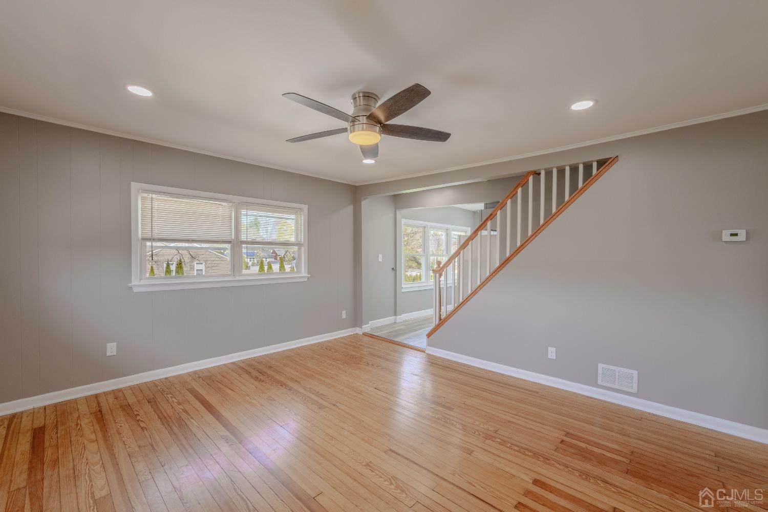 49 Riva Avenue, Unit 2 Milltown, NJ 08850 - Photo 13 of 22 a view of an empty room with wooden floor and a window