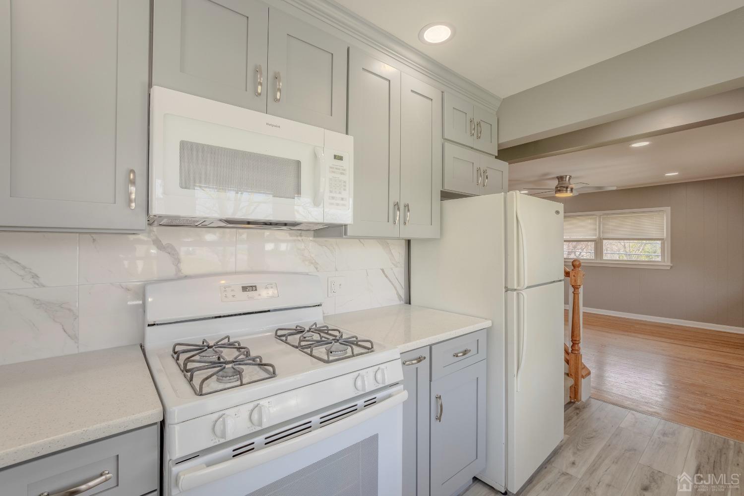 49 Riva Avenue, Unit 2 Milltown, NJ 08850 - Photo 15 of 22 a kitchen with cabinets a refrigerator and a stove
