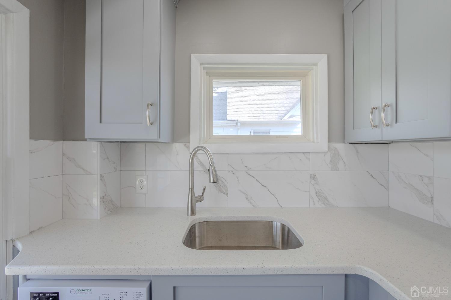 49 Riva Avenue, Unit 2 Milltown, NJ 08850 - Photo 16 of 22 a bathroom with a sink and cabinets