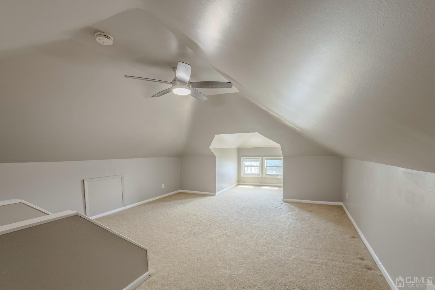 49 Riva Avenue, Unit 2 Milltown, NJ 08850 - Photo 17 of 22 an empty room with chandelier fan and windows