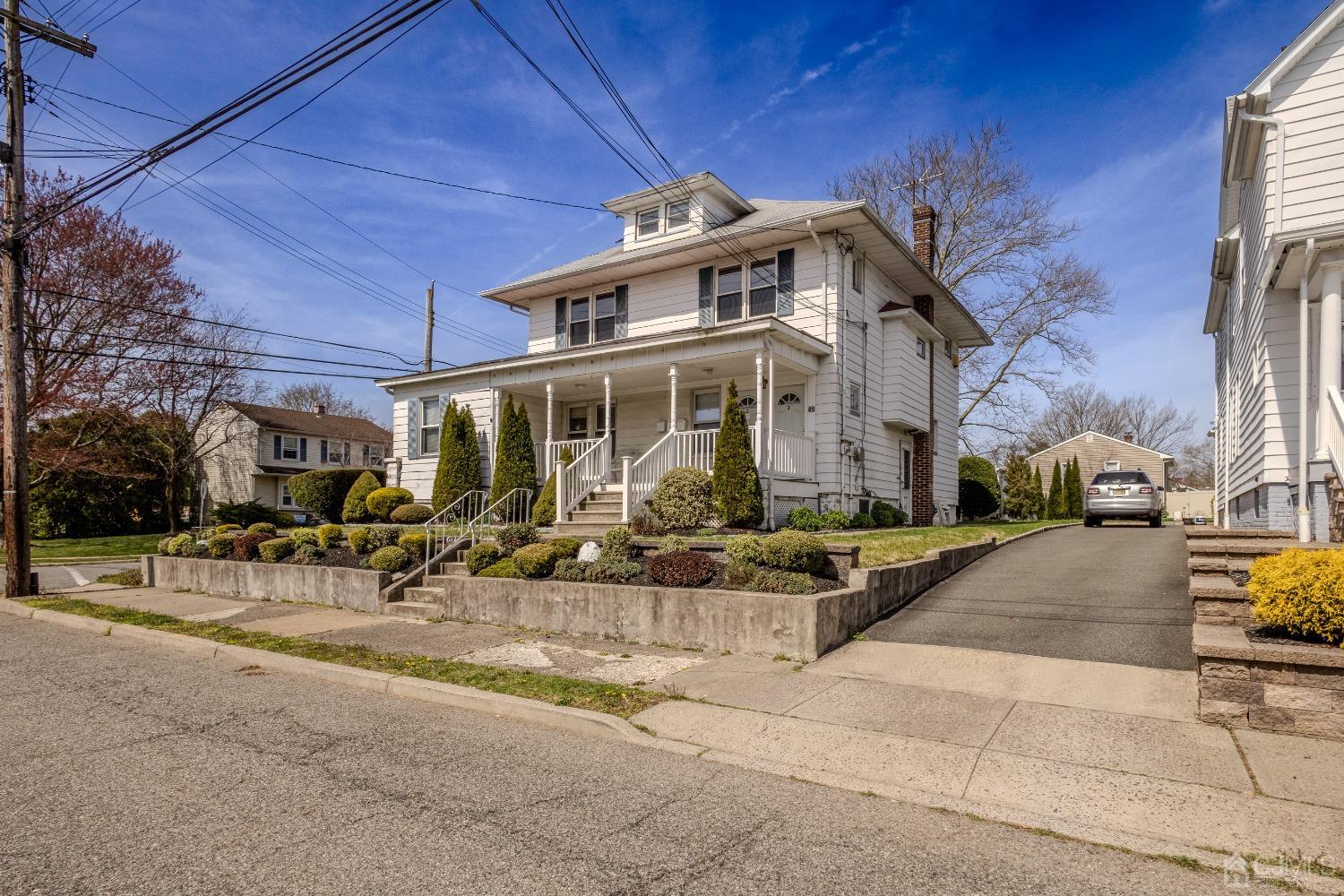 49 Riva Avenue, Unit 2 Milltown, NJ 08850 - Photo 2 of 22 a front view of a building with sitting area