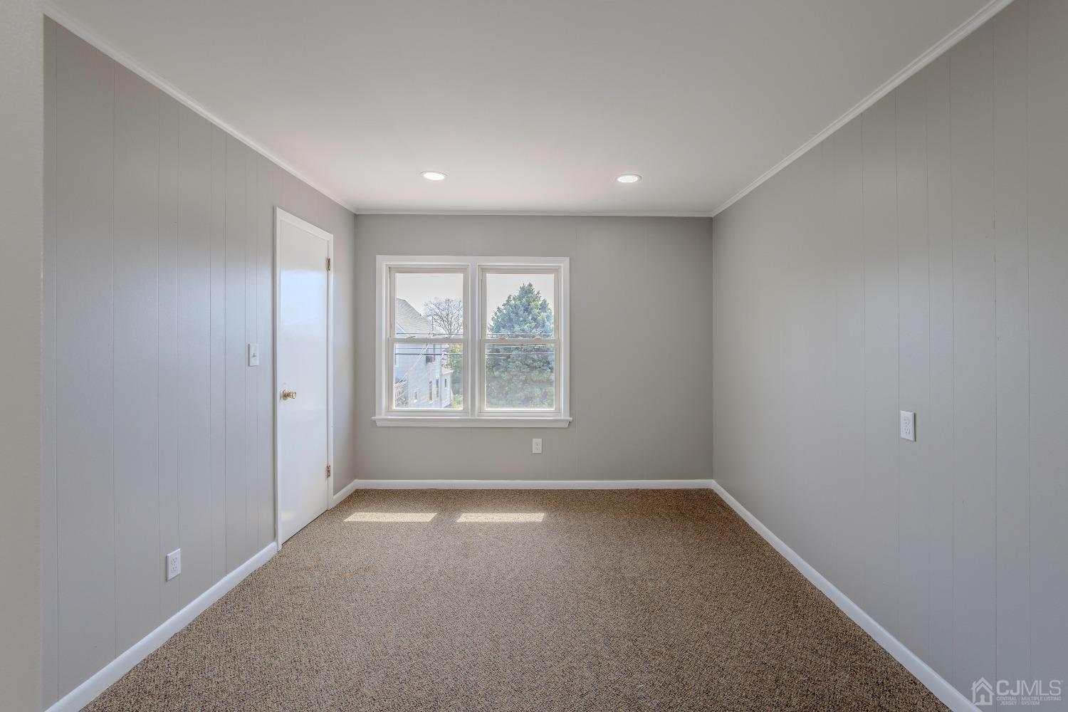 49 Riva Avenue, Unit 2 Milltown, NJ 08850 - Photo 4 of 22 an empty room with windows