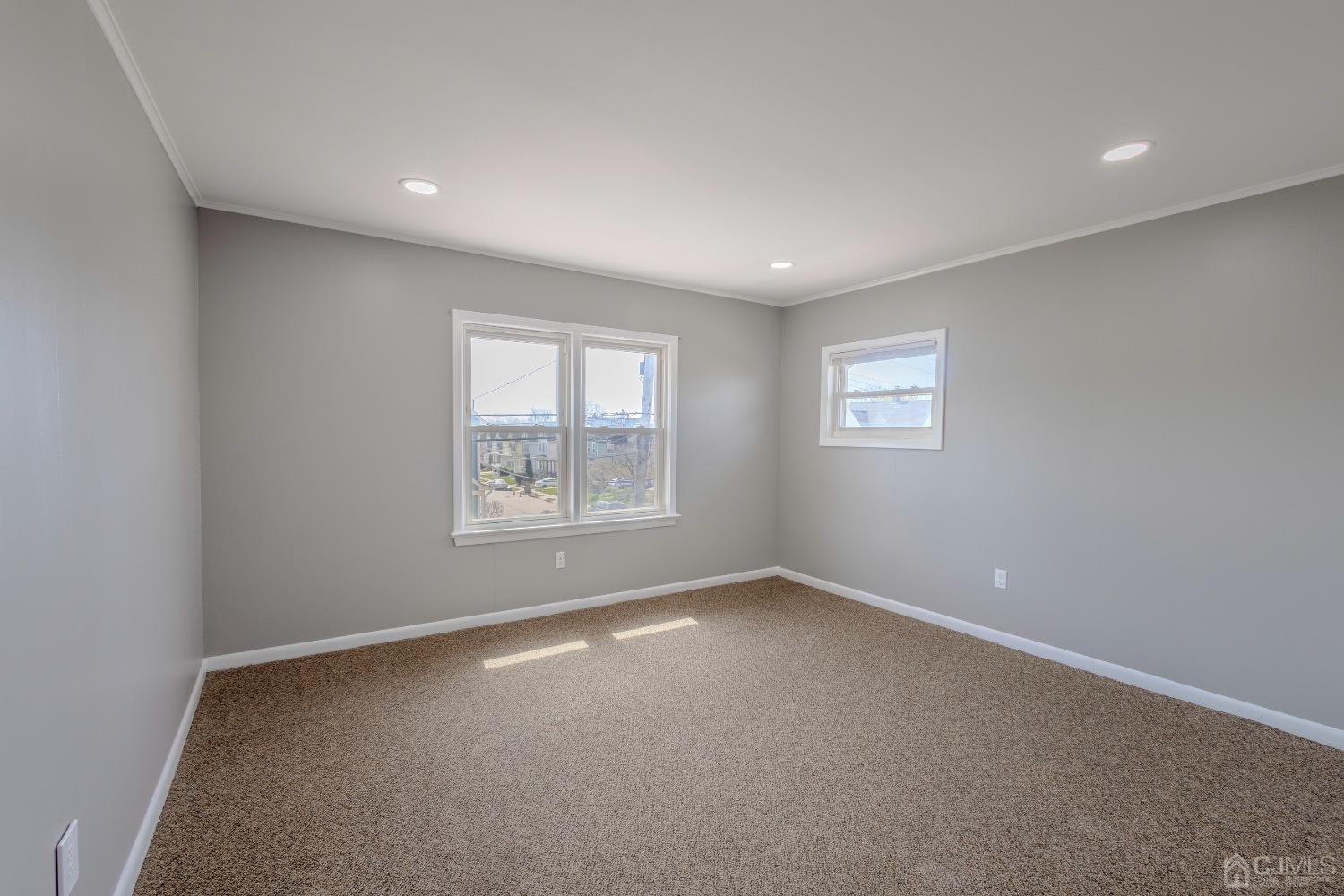 49 Riva Avenue, Unit 2 Milltown, NJ 08850 - Photo 8 of 22 an empty room with windows