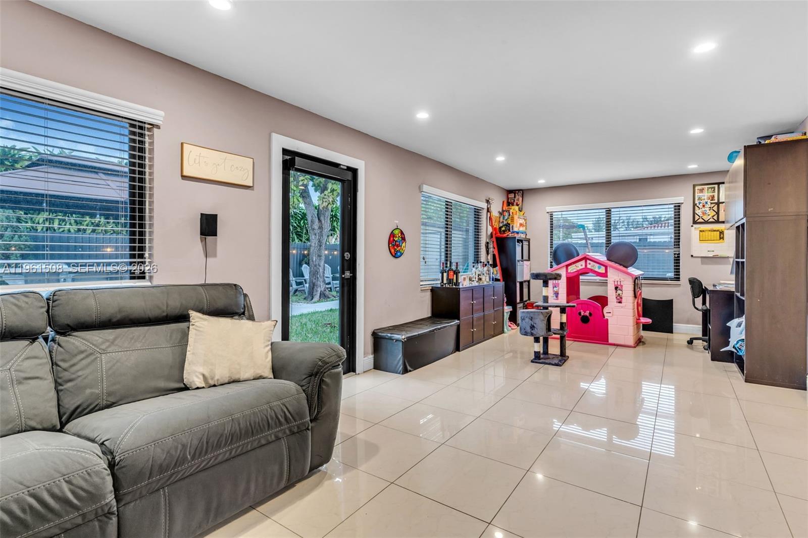 7585 Southwest 28th Street Miami, FL 33155 - Photo 13 of 28 a living room with furniture and a window