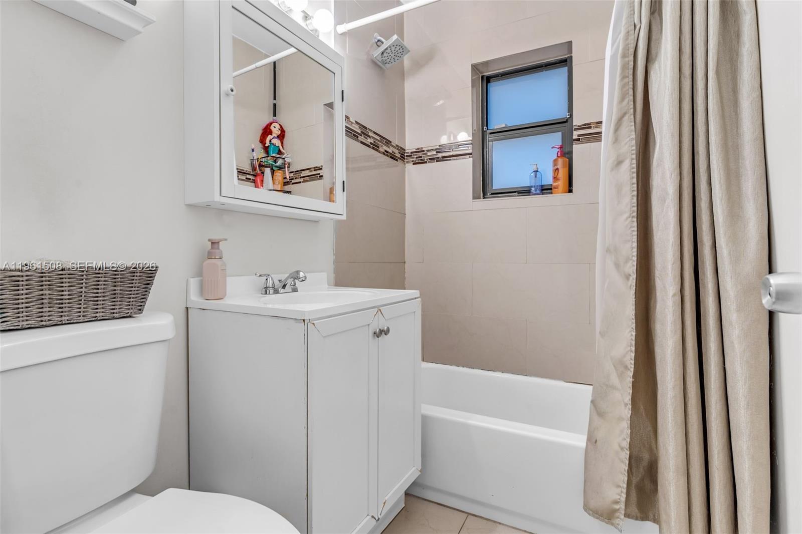 7585 Southwest 28th Street Miami, FL 33155 - Photo 17 of 28 a bathroom with a sink a toilet and a bathtub