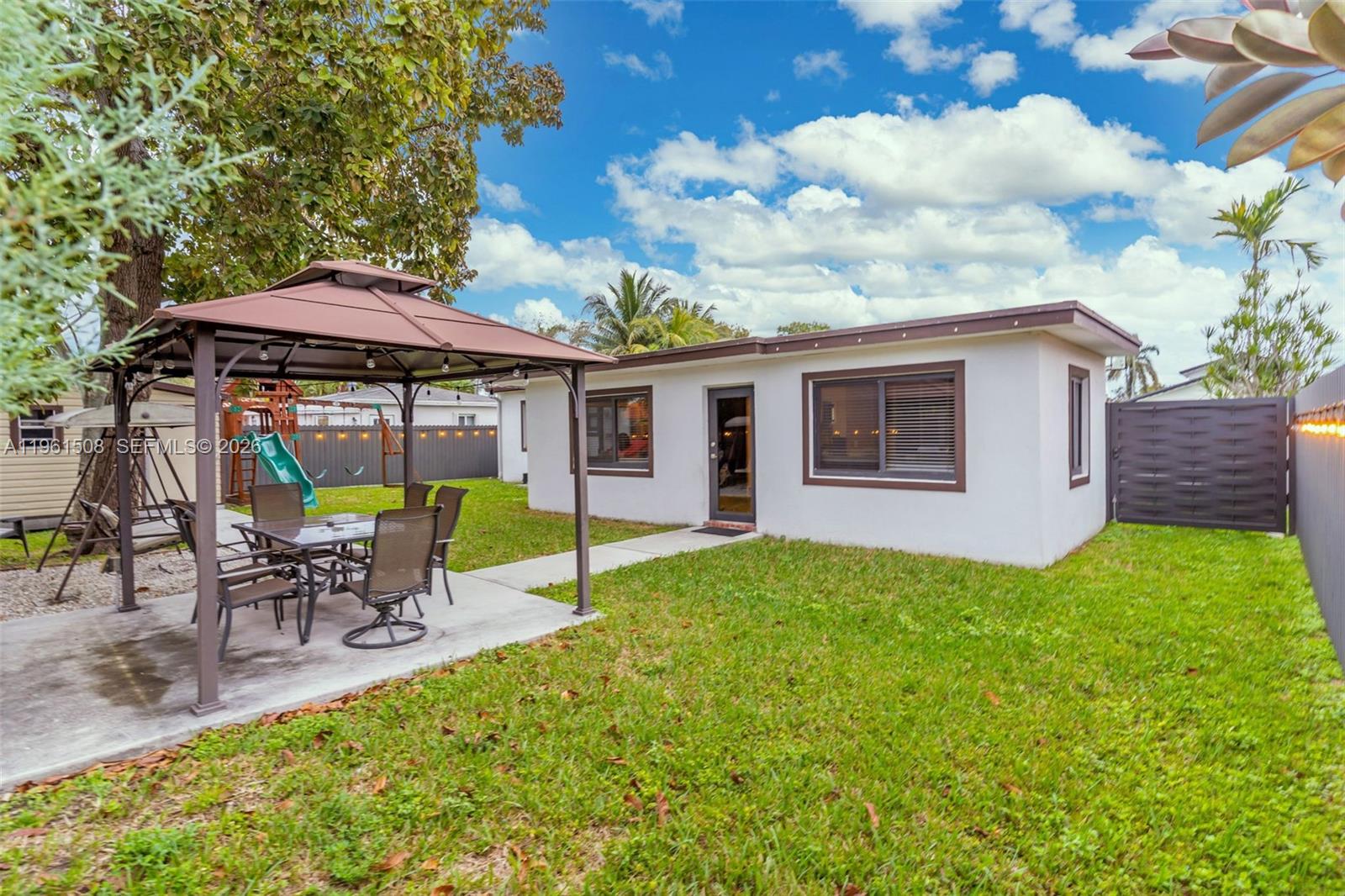 7585 Southwest 28th Street Miami, FL 33155 - Photo 21 of 28 a view of a house with backyard sitting area and garden