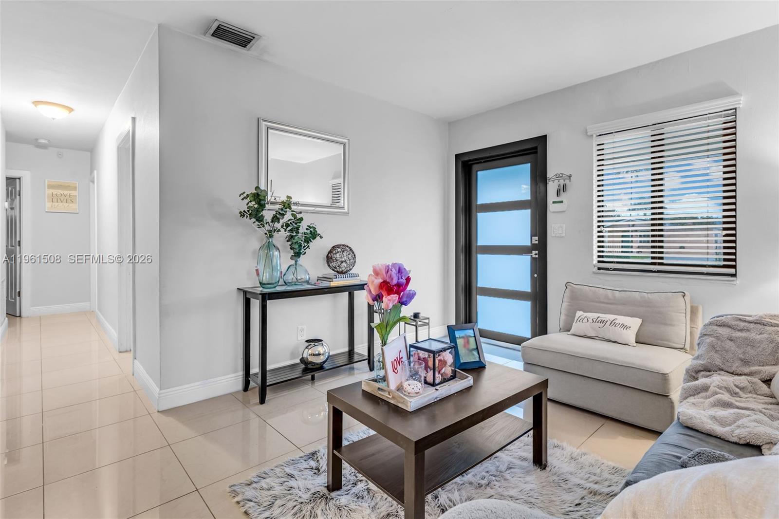 7585 Southwest 28th Street Miami, FL 33155 - Photo 6 of 28 a living room with furniture and a potted plant