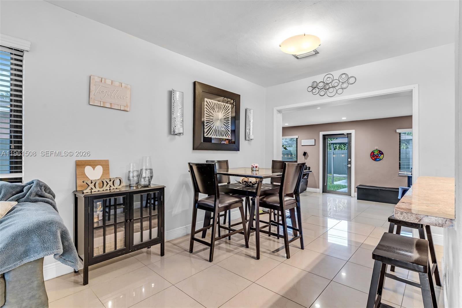 7585 Southwest 28th Street Miami, FL 33155 - Photo 7 of 28 a view of a dining room with furniture and chandelier