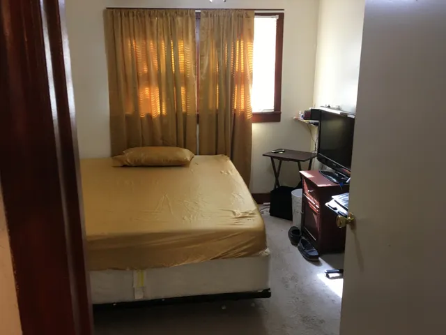 a bedroom with a bed and a mirror