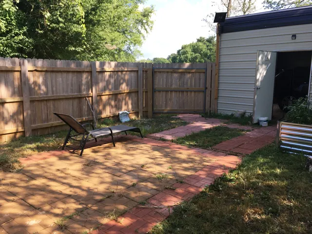 a view of a house with a yard covered in snow