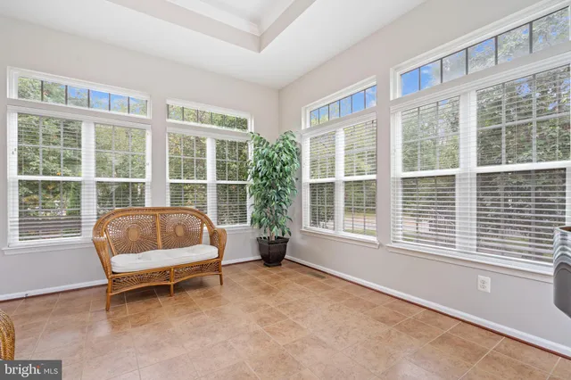 a living room with furniture a fireplace and a large window