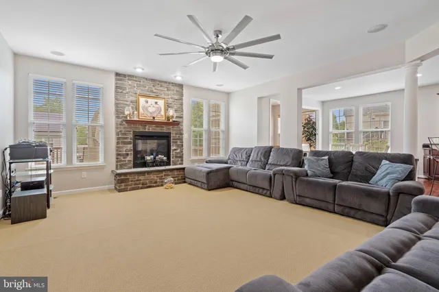 a living room with a couch and ceiling fan