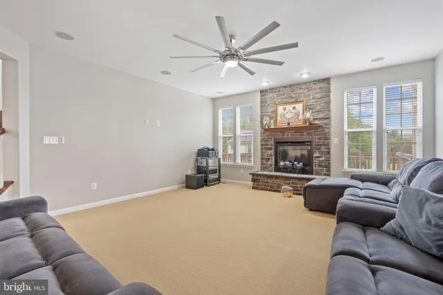 a kitchen with a refrigerator a stove top oven a sink dishwasher and white cabinets next to a window