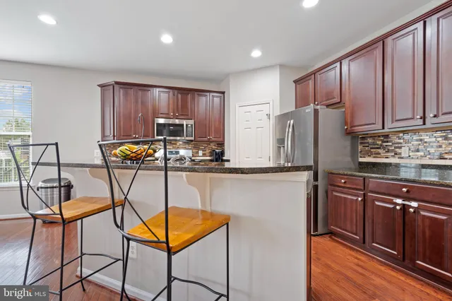 a kitchen with a refrigerator a stove top oven a sink and dishwasher