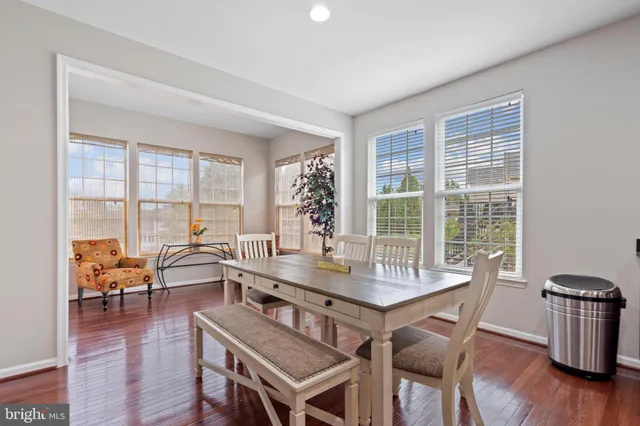 a dining room with furniture and wooden floor