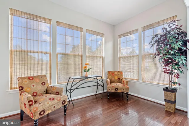 a room with furniture a desk and chair with wooden floor