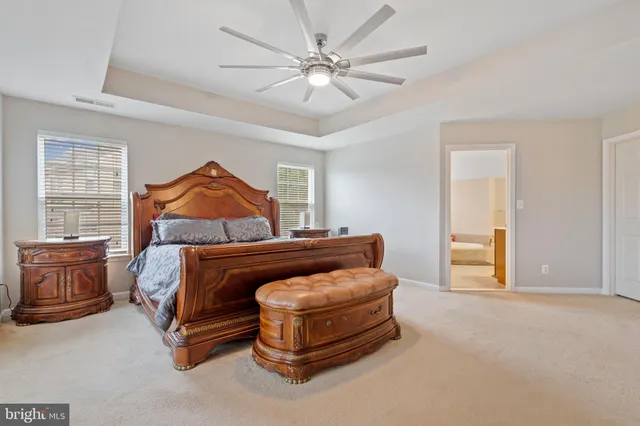 a bedroom with a large bed and a large window