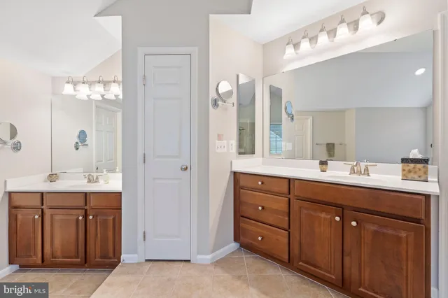 a bedroom with a bed next to a window with the view of bathroom