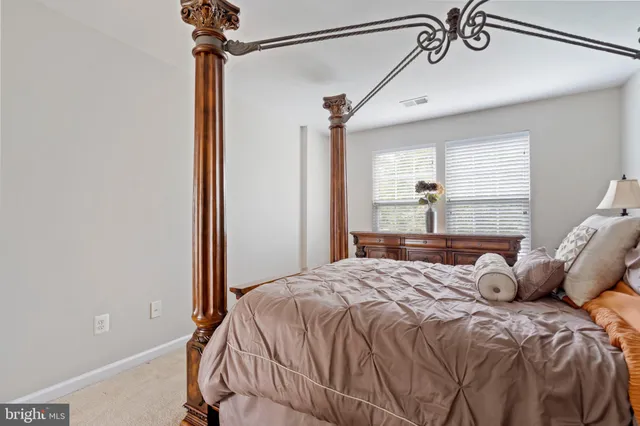 a bed sitting in a bedroom next to a window