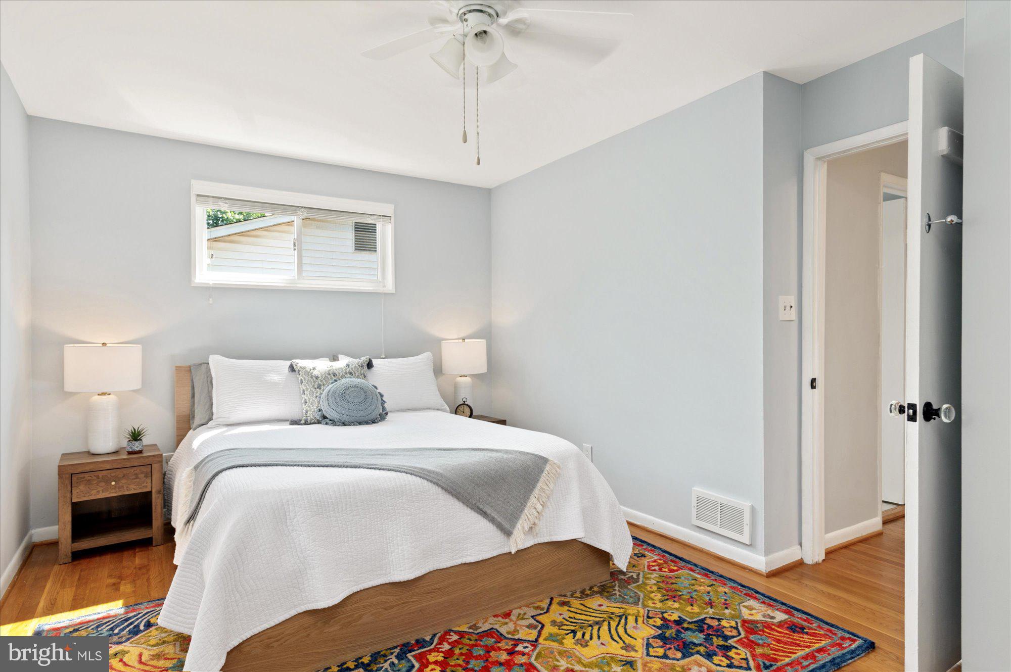 11201 Lombardy Road Silver Spring, MD 20901 - Photo 15 of 31 a bedroom with a bed and a chandelier