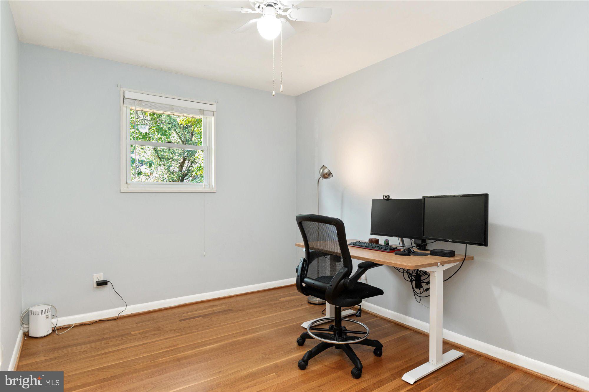 11201 Lombardy Road Silver Spring, MD 20901 - Photo 17 of 31 a view of a workspace with wooden floor and white walls