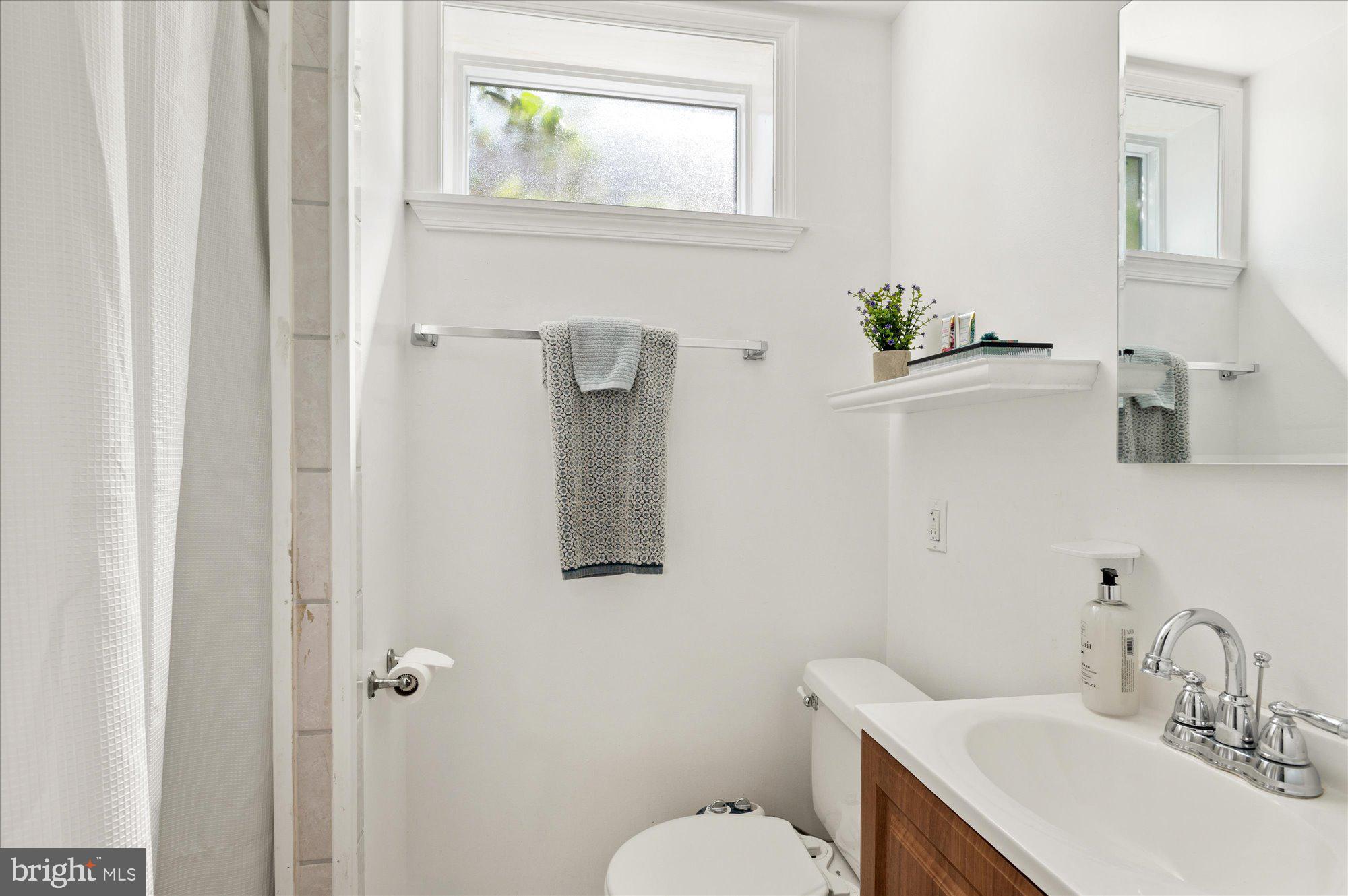 11201 Lombardy Road Silver Spring, MD 20901 - Photo 23 of 31 a bathroom with a sink toilet and vanity